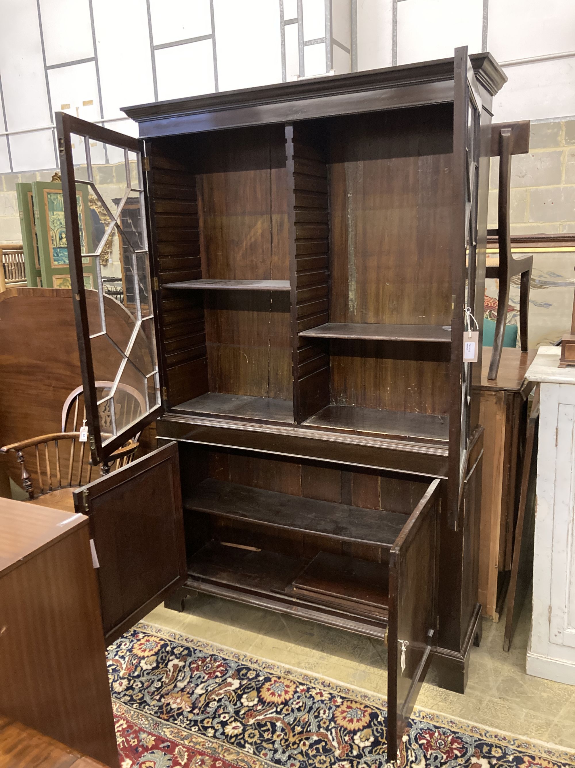 A reproduction George III style mahogany glazed bookcase, length 126cm, depth 34cm, height 206cm